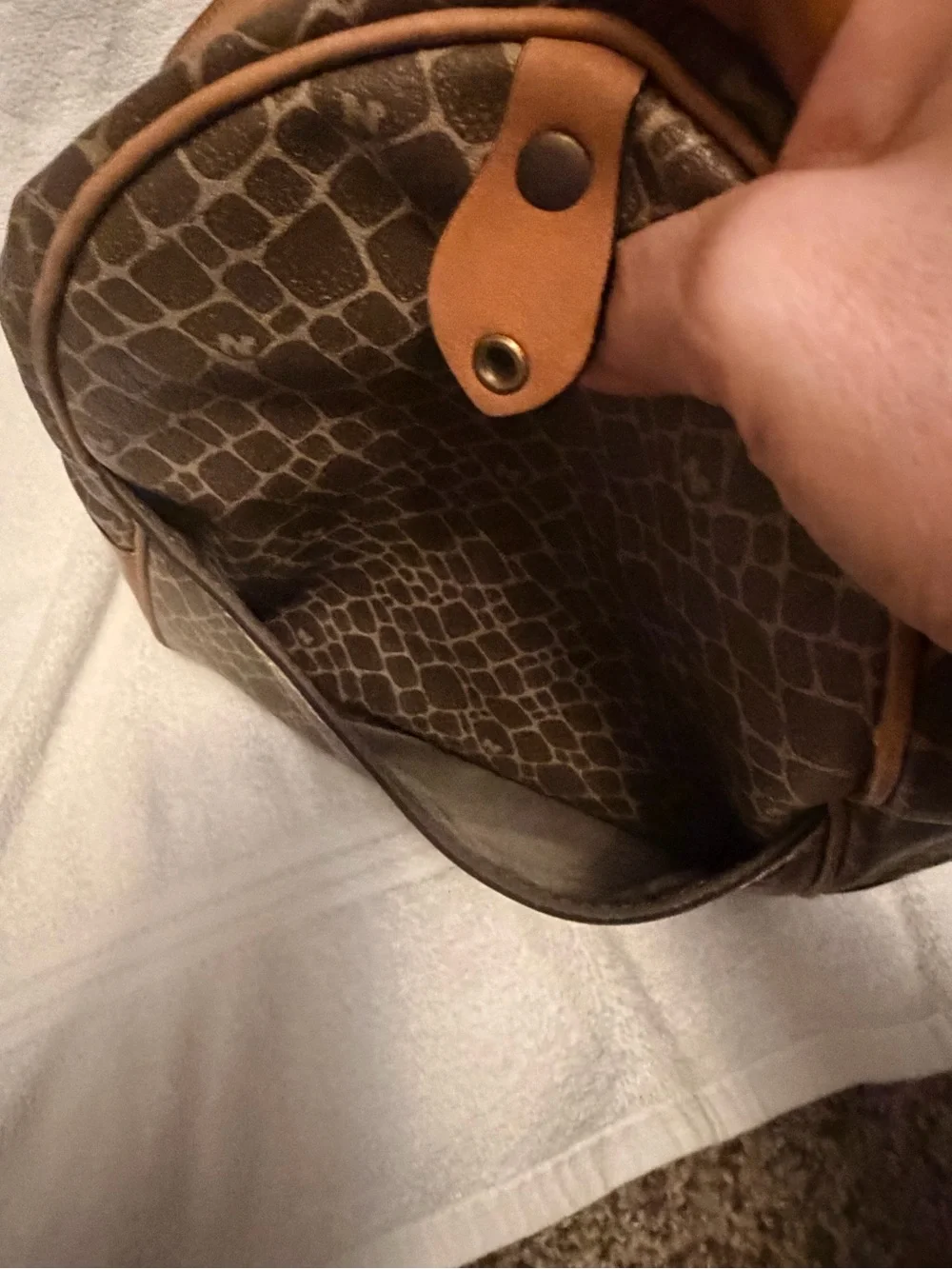 Nina Ricci Brown Patterned Duffel with Tan Trim. Has lock and key.